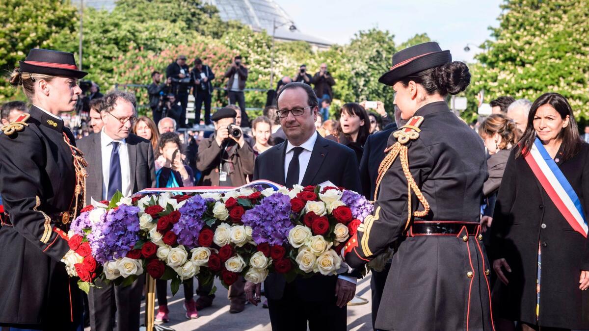French President Francois Hollande carries a wreath during a ceremony on April 24, 2017, in Paris marking the 102nd anniversary of the Armenian genocide.