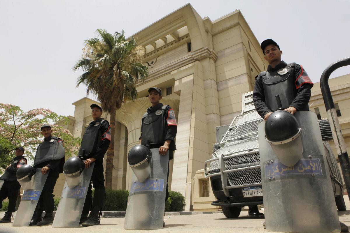 Egyptian anti-riot police stand guard in front of the Supreme Constitutional Court in Cairo. The high court ruled that Egypt's upper house of parliament and constitutional panel were illegally elected.
