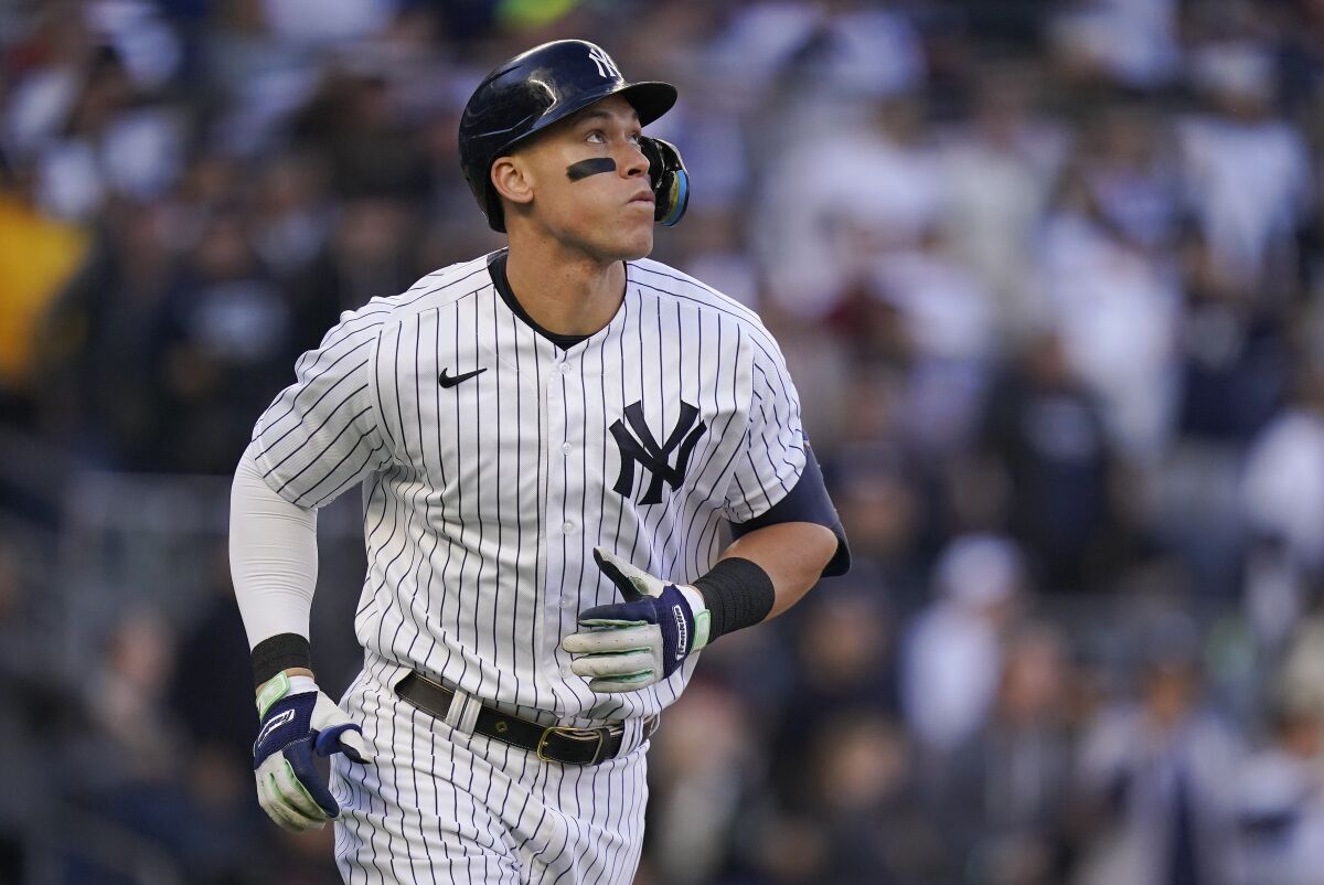 New York Yankees' Aaron Judge watches his solo home run ball during the second inning of Game 5 of an American League Division baseball series against the Cleveland Guardians, Oct. 18, 2022, in New York. Judge has agreed to return to the Yankees on a $360 million, nine-year contract, according to a person familiar with the deal. The person spoke to The Associated Press on Wednesday, Dec. 7, 2022 because the deal had not been announced. (AP Photo/Frank Franklin II, file)