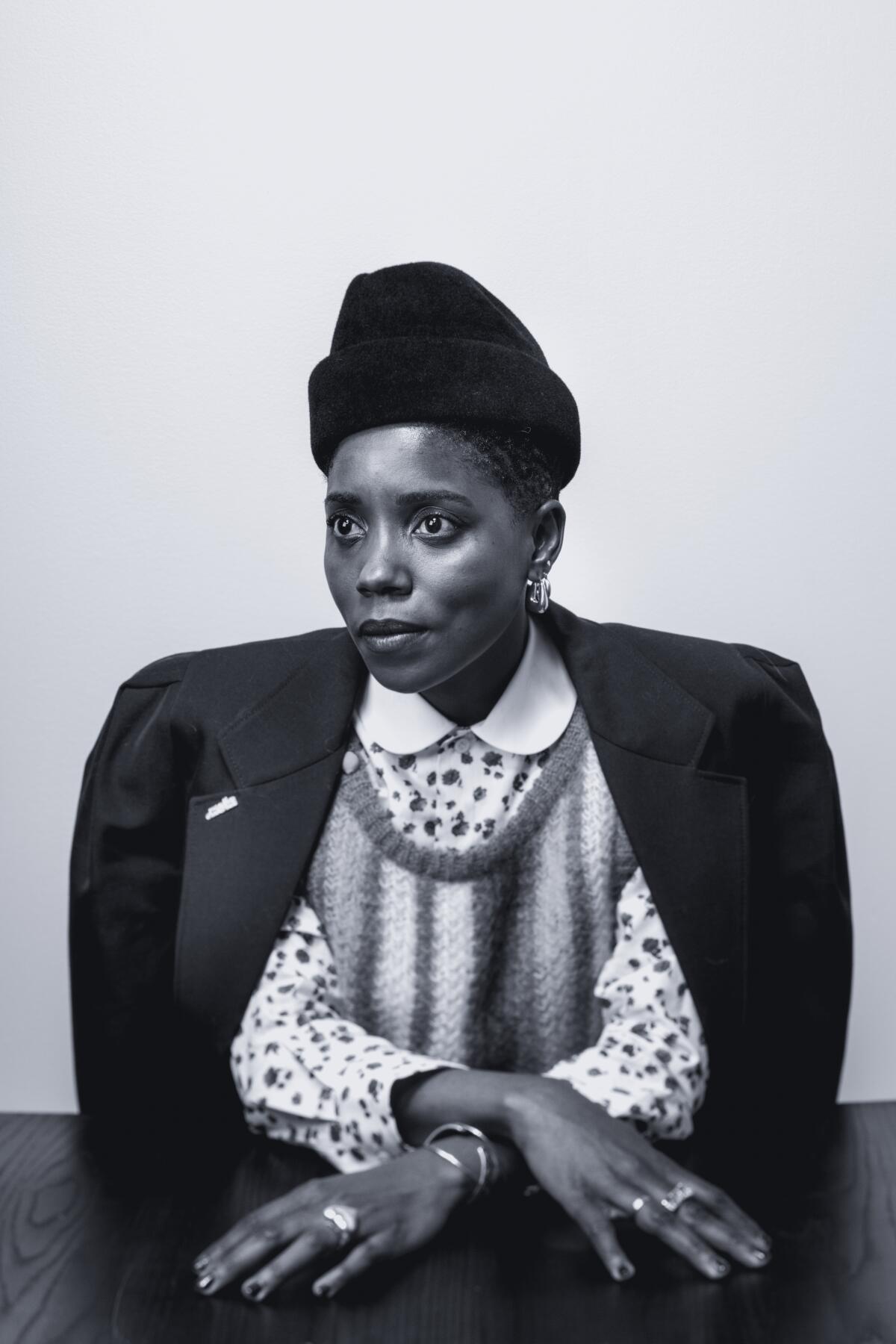 A black woman sitting at a table