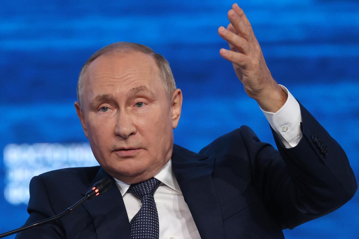 Russian President Vladimir Putin gesturing