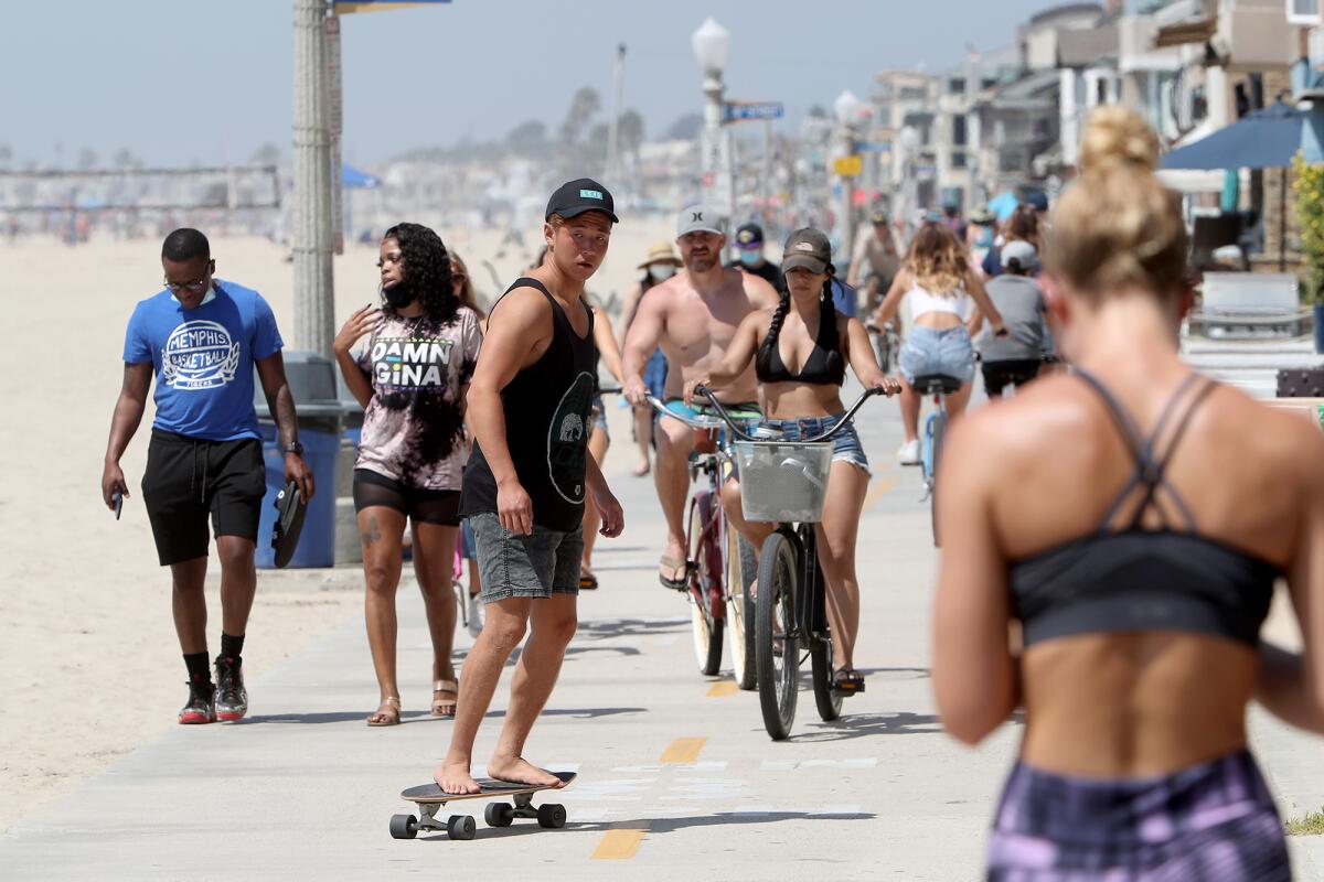 A skateboarder cruises south along the bike path towards Newport Pier on Friday.