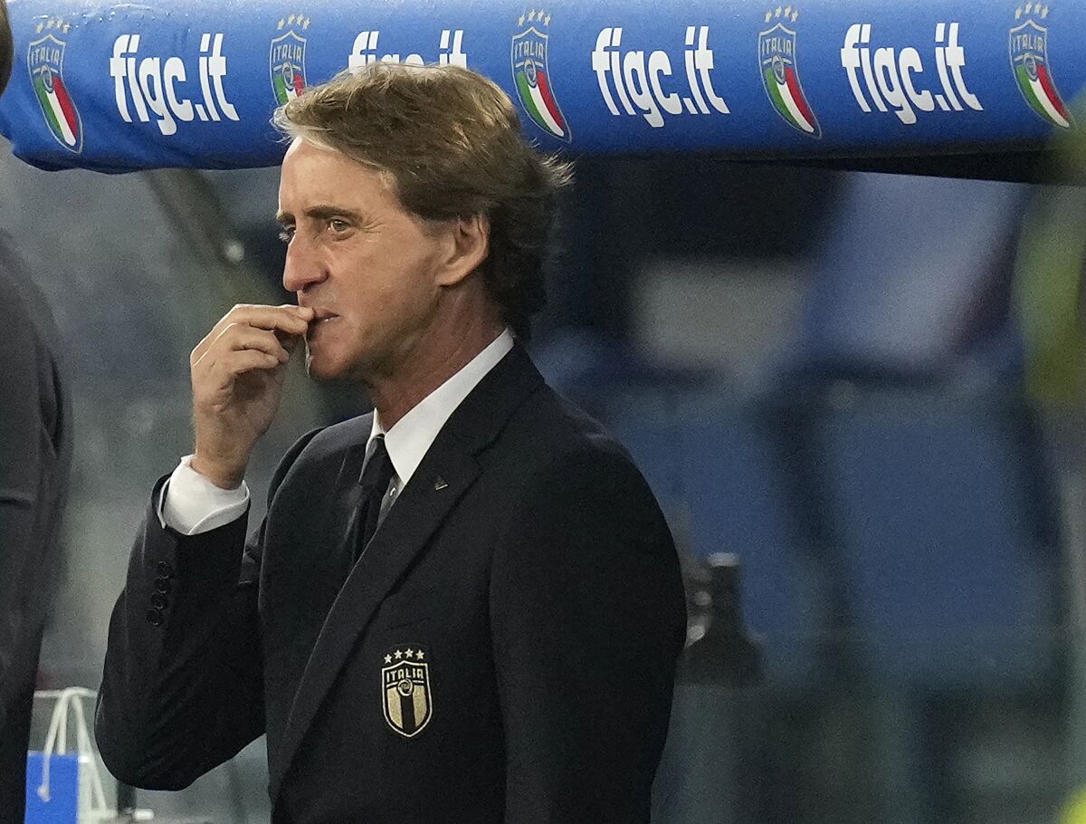 Italy coach Roberto Mancini stands in the dugout before the World Cup 2022 group C qualifying soccer match between Italy and Switzerland at Rome's Olympic stadium, Friday, Nov. 12, 2021. (AP Photo/Gregorio Borgia)