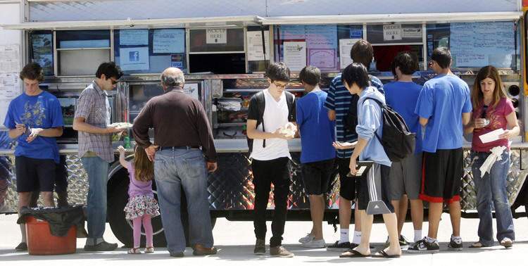 Charlie Getzen 16, center, gets some food from the Bull Kogi food truck during TACH Bash, an event where all proceeds benefit the Children's Hospital Adolescent Unit. The event took place at the Memorial Park in La Canada on Saturday, June 4, 2011. 30 percent of Bull Kogi sales will also be donated to the Children's Hospital.