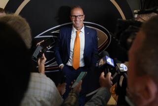 Greg Cronin speaks to reporters during a press conference announcing him as the new head coach.