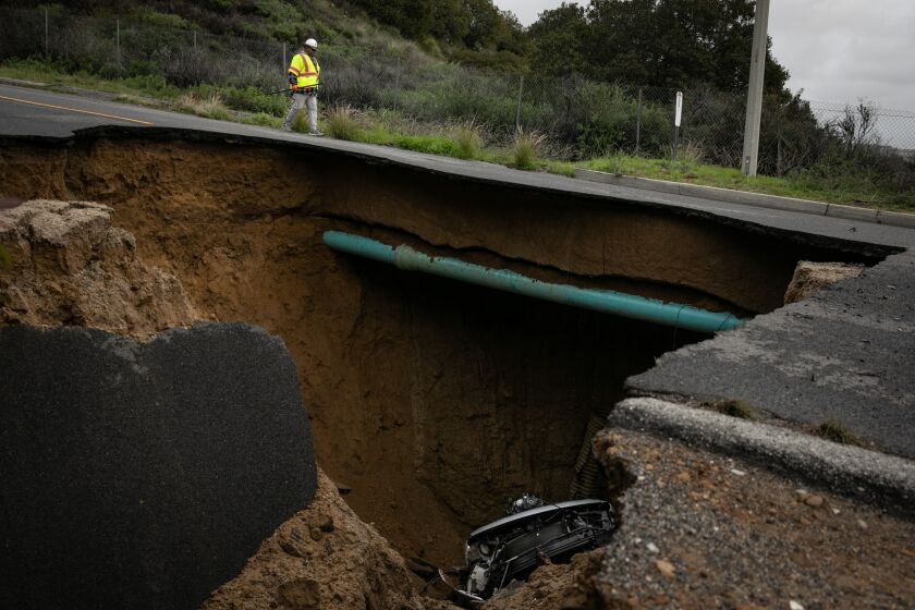 CHATSWORTH, CA - JANUARY 10: A sinkhole that swallowed two cars on Iverson Road south of Zaltana Street, beneath the 118 Freeway on Tuesday, Jan. 10, 2023 in Chatsworth, CA. (Jason Armond / Los Angeles Times)