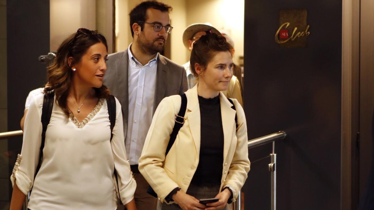 Amanda Knox, right, exits the airport from a side entrance upon her arrival June 13 in in Milan, Italy.