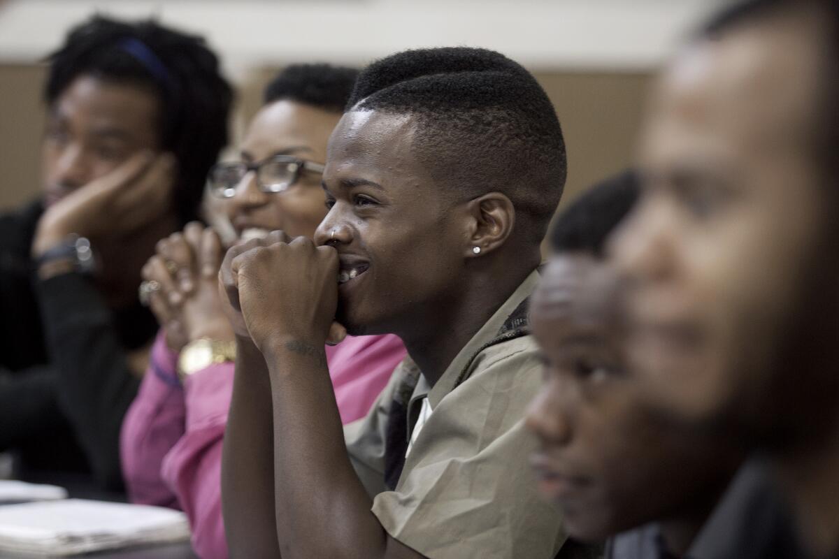 Marcus Davis, 21, and other high school graduates and seniors attend a College Bridge class in 2014.