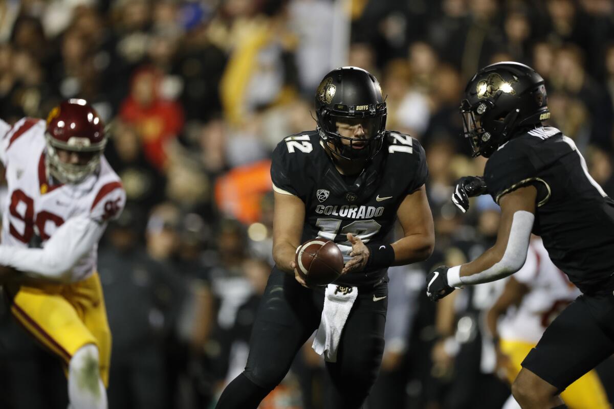 Colorado quarterback Steven Montez hands the ball off in the second half against USC on Oct. 25 in Boulder, Colo.