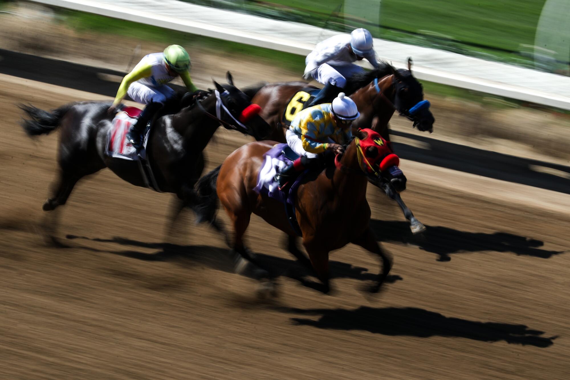 Horses sprint down the final stretch during the third race of Friday's opening day at Del Mar.