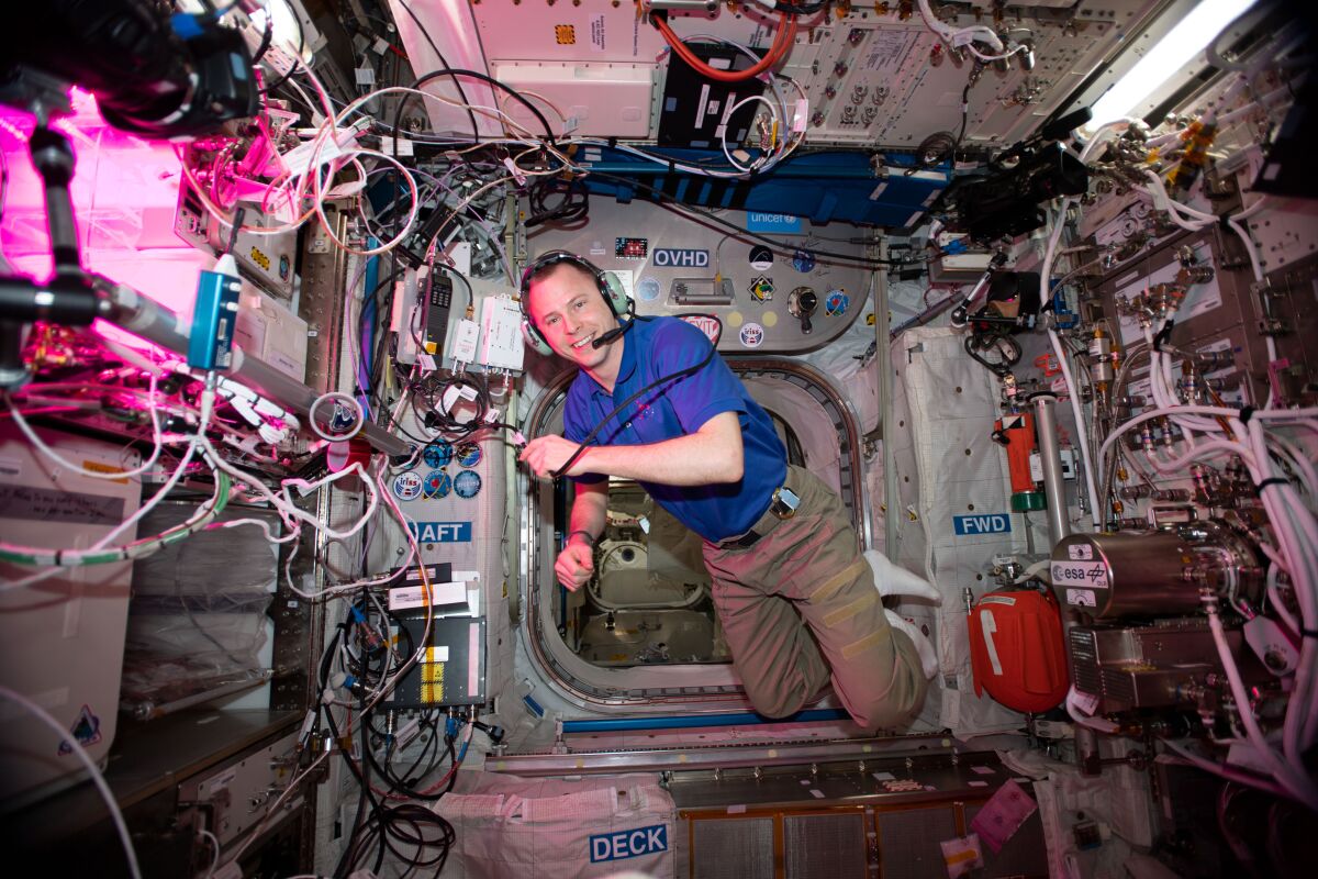 NASA astronaut Nick Hague floats inside Europe's Columbus laboratory module during a HAM radio session.