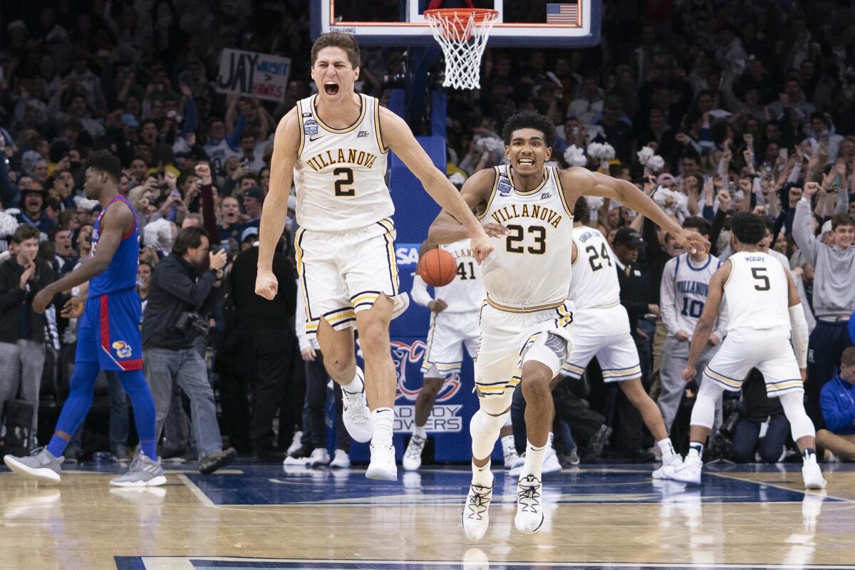 Villanova's Collin Gillespie (2) and Jermaine Samuels (23) react after defeating Kansas on Saturday in Philadelphia.