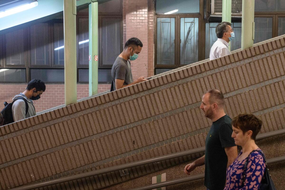 Pedestrians with -- and without -- face masks out and about in Hong Kong.