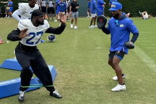 Rams cornerback Tre’Davious White works with defensive backs coach Aubrey Pleasant.