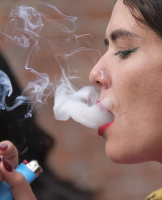 A woman blowing smoke