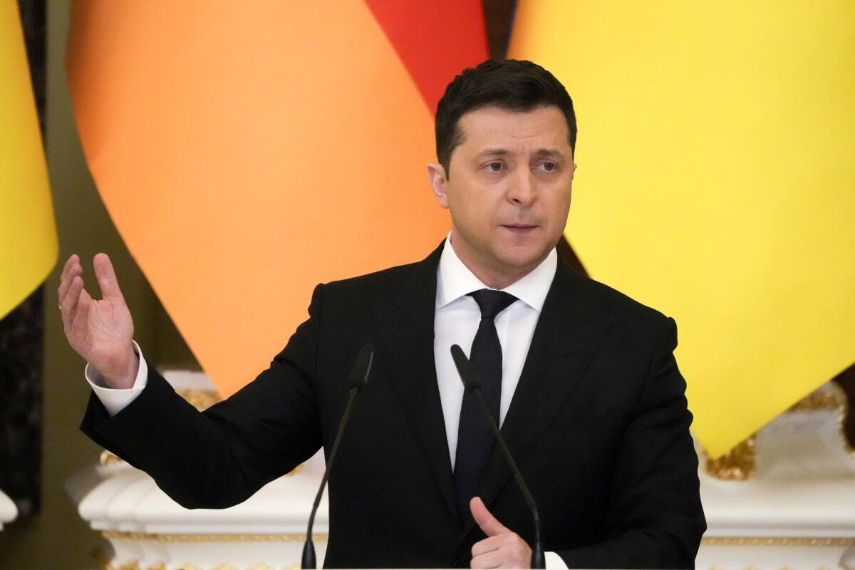 Ukrainian President Volodymyr Zelensky gestures during a news conference.