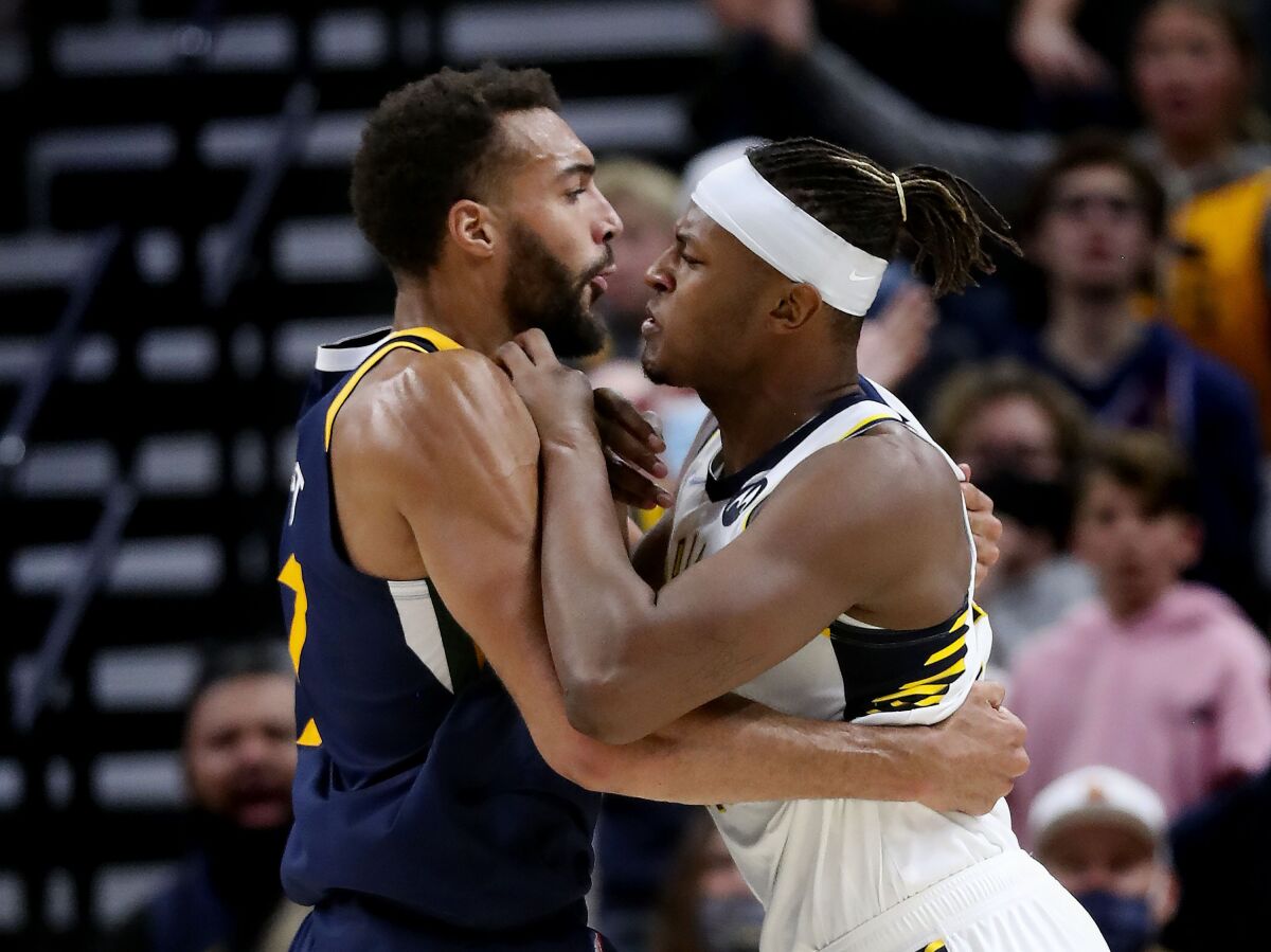 Utah Jazz center Rudy Gobert, left, and Indiana Pacers center Myles Turner start a skirmish during the fourth quarter of an NBA basketball game in Salt Lake City on Thursday, Nov. 11, 2021. Both players, and the Jazz's Donovan Mitchell and Joe Ingles, were ejected. (Laura Seitz/The Deseret News via AP)