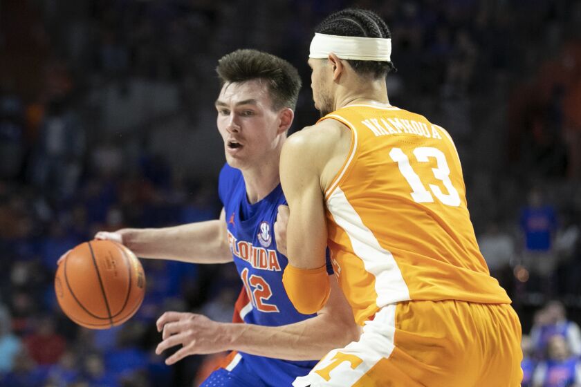 Florida forward Colin Castleton (12) tries to get around Tennessee forward Olivier Nkamhoua (13) during the second half of an NCAA college basketball game, Wednesday, Feb. 1, 2023, in Gainesville, Fla. (AP Photo/Alan Youngblood)