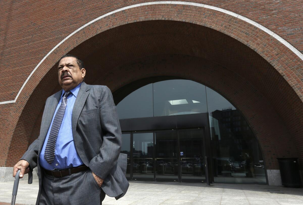 Former Salvadoran Col. Inocente Orlando Montano leaves a federal court in Boston. He was sentenced to 21 months in jail for immigration violations.