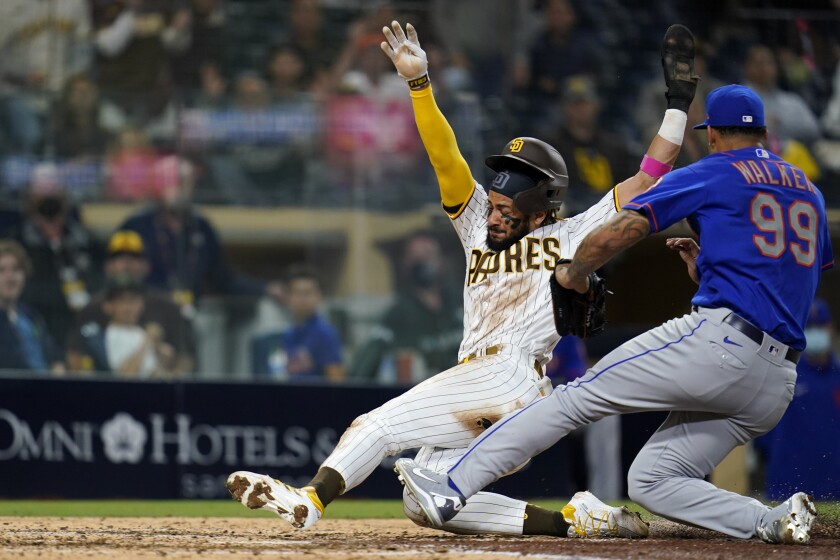 San Diego Padres' Fernando Tatis Jr. scores from third on a wild pitch by New York Mets pitcher Taijuan Walker (99) during the fifth inning of a baseball game Thursday, June 3, 2021, in San Diego. (AP Photo/Gregory Bull)