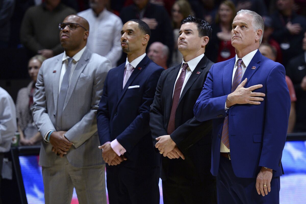 Assistant coach Jay Morris (second from left) has been hired by USC.