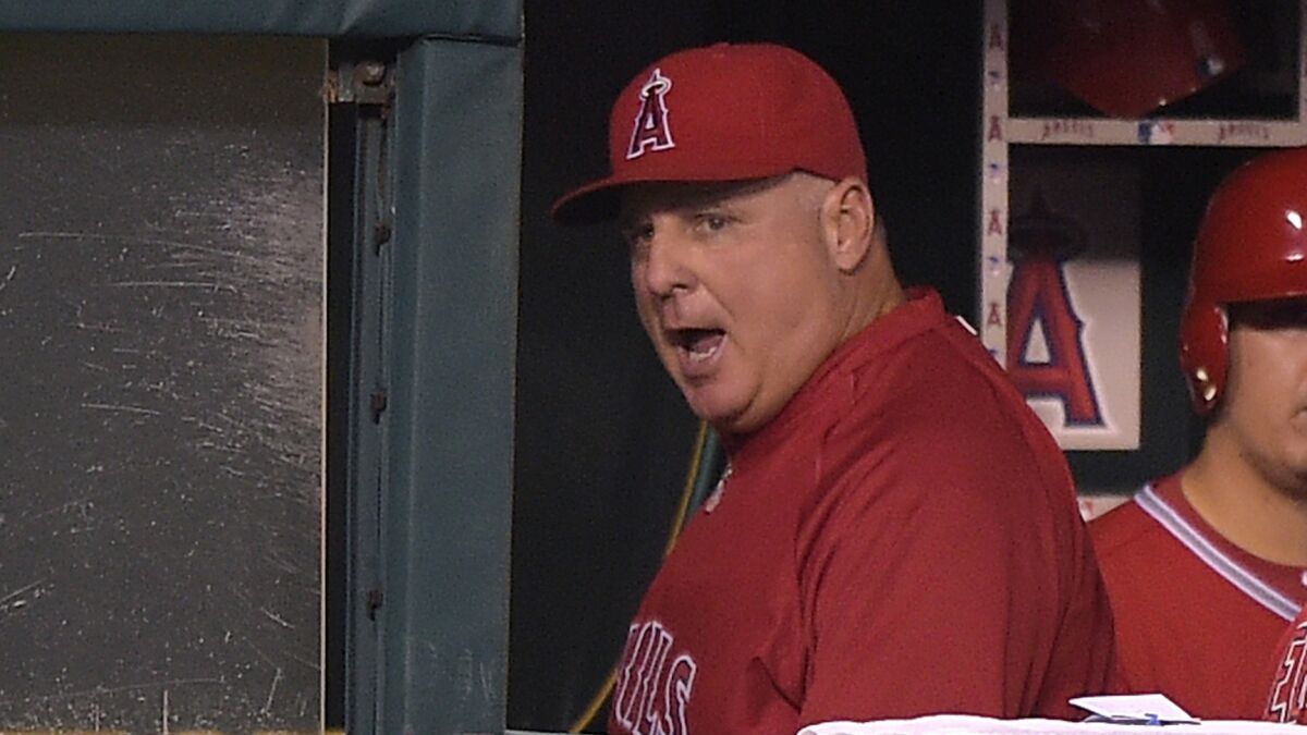 Angels Manager Mike Scioscia yells as he heads for the clubhouse after being ejected from Monday's game against the Oakland Athletics. Scioscia was still upset Tuesday with a reviewed call on Monday that reduced a Mike Trout home run to a double.