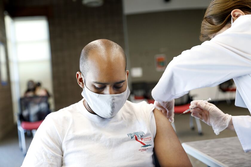 CARSON-CA-SEPTEMBER 16, 2021: CSUDH student Wesley Campbell, 29, receives a shot by Rite Aid pharmacist Lanchi Vu during the final of two pop-up COVID-19 vaccination clinics hosted by Cal State Dominguez Hills and Rite Aid for CSUDH students, faculty, staff and community members on campus in Carson on Thursday, September 16, 2021. (Christina House / Los Angeles Times)