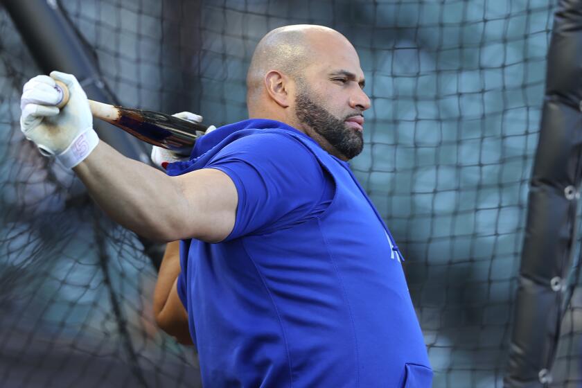 Los Angeles Dodgers' Albert Pujols warms up before Game 5 of a baseball National League Division Series.
