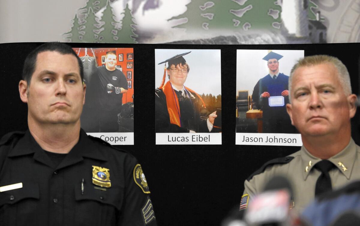 Portland Police Sgt. Peter Simpson, left, and Douglas County Sheriff John Hanlin at a news conference in Roseburg with photos of three victims: Quinn Cooper, Lucas Eibel and Jason Dale Johnson, from left.