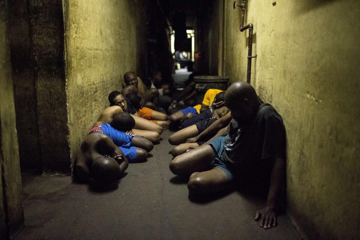 Zulu hostel dwellers wait in a hallway during a joint raid by South African police and the military outside Johannesburg on April 21.