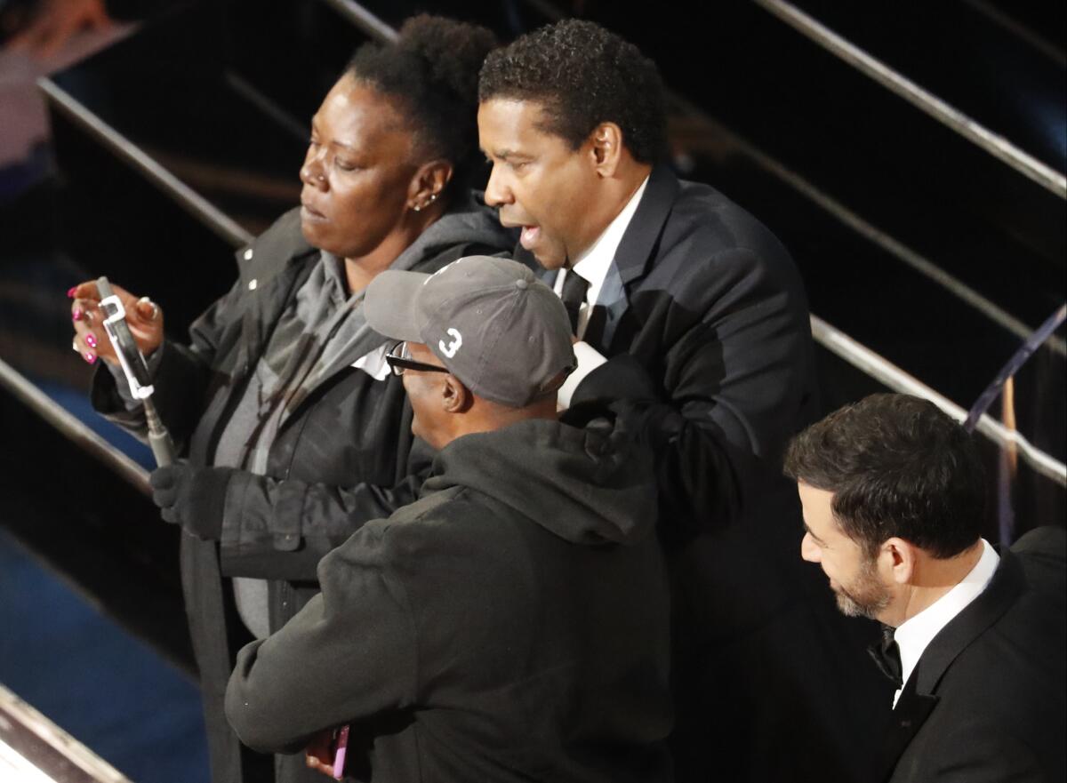 Denzel Washington mock-marries an engaged couple during the Oscars.