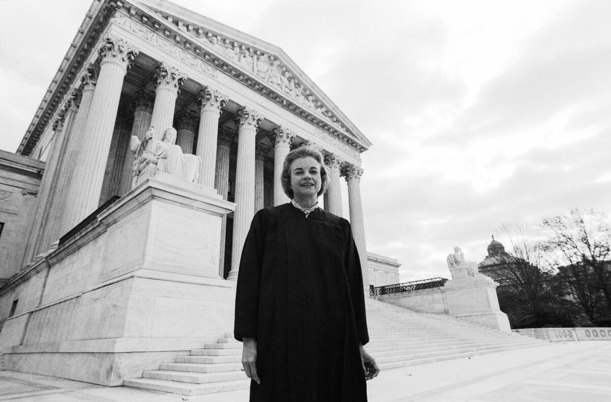 A woman in judge's robe stands outside the Supreme Court building 