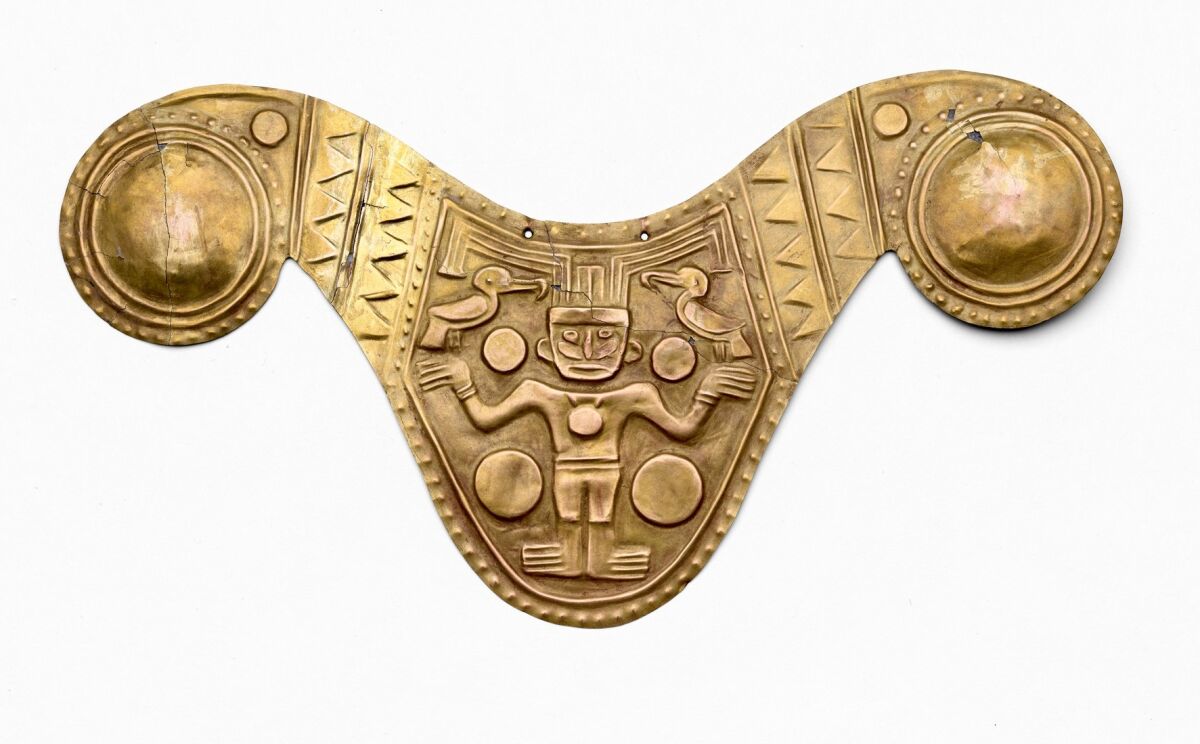 A gold alloy breastplate with a mythic being at the center.
