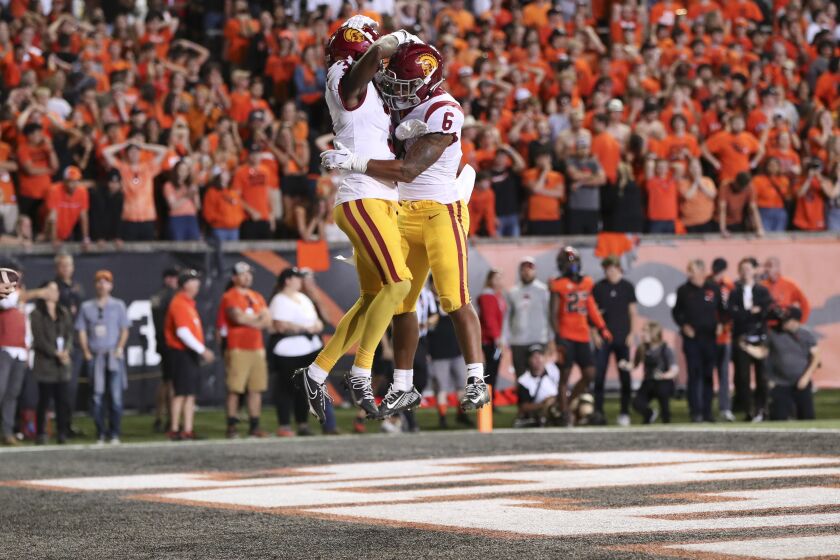 USC receiver Jordan Addison celebrates his touchdown catch by jumping in the air with running back Austin Jones