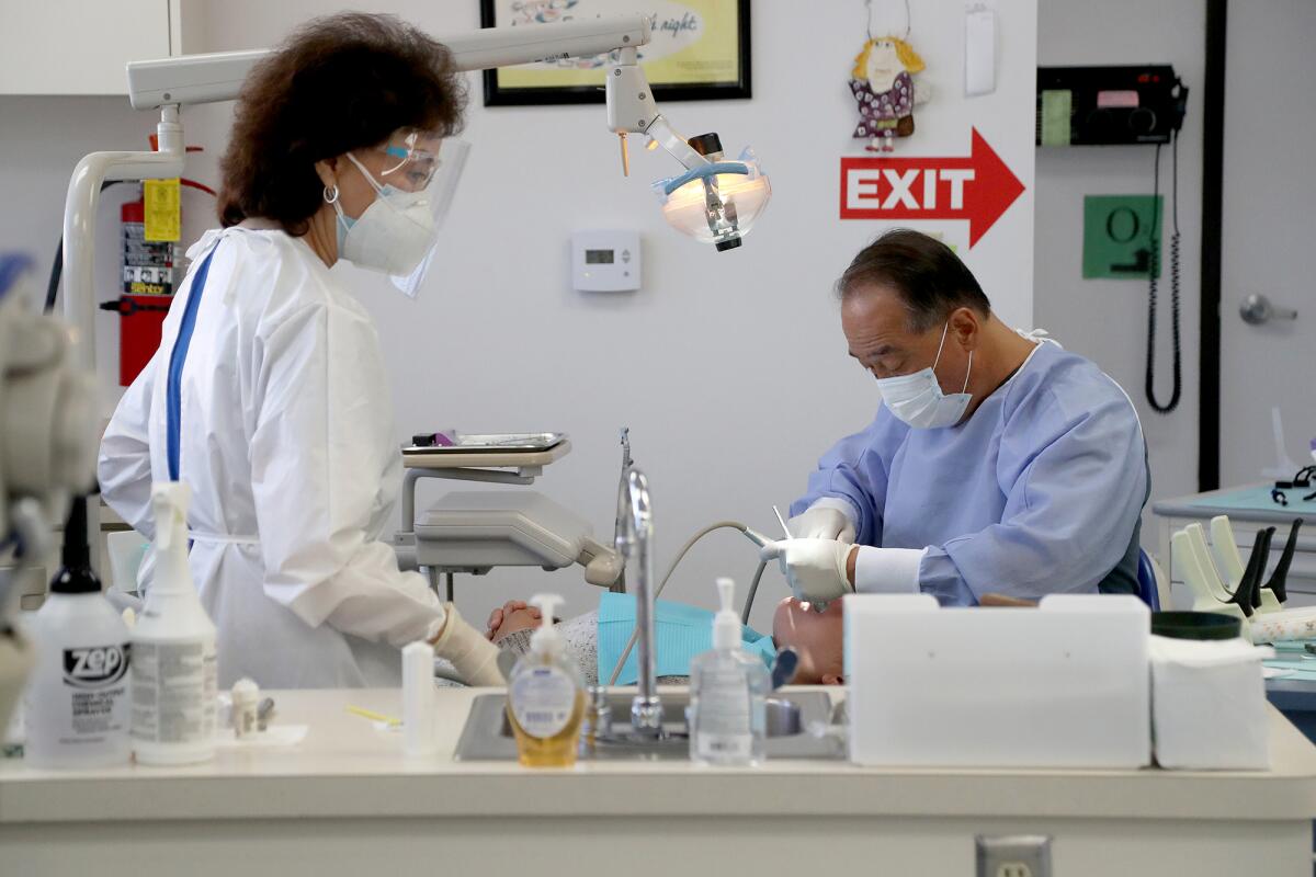 Dr. Greg Navarrete, right, and Anne Wong, a volunteer and director of the Cheri Harris Dental Center.