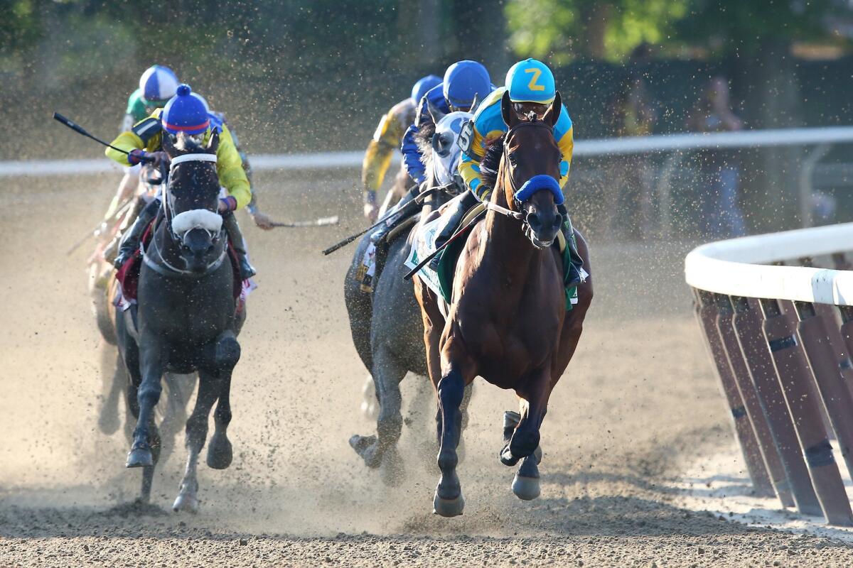 American Pharoah makes the final turn with the lead in the 147th Belmont Stakes on Saturday.