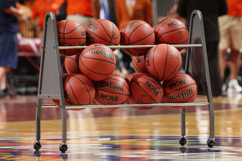 SUNRISE, FL - DECEMBER 21: NCAA basketballs in a rack on the court.