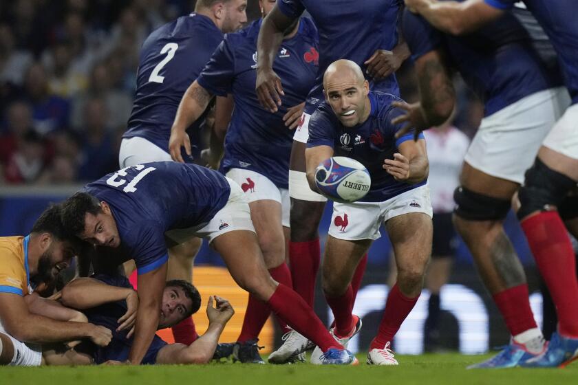 France's Maxime Lucu, centre, passes the ball during the Rugby World Cup Pool A match between France and Uruguay at the Pierre Mauroy stadium in Villeneuve-d'Ascq, near Lille, France, Thursday, Sept. 14, 2023. (AP Photo/Thibault Camus)
