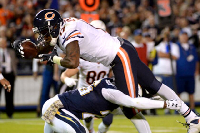 Bears receiver Alshon Jeffrey is tackled by Chargers defensive back Patrick Robinson after making a reception during a game Nov. 9 in San Diego.