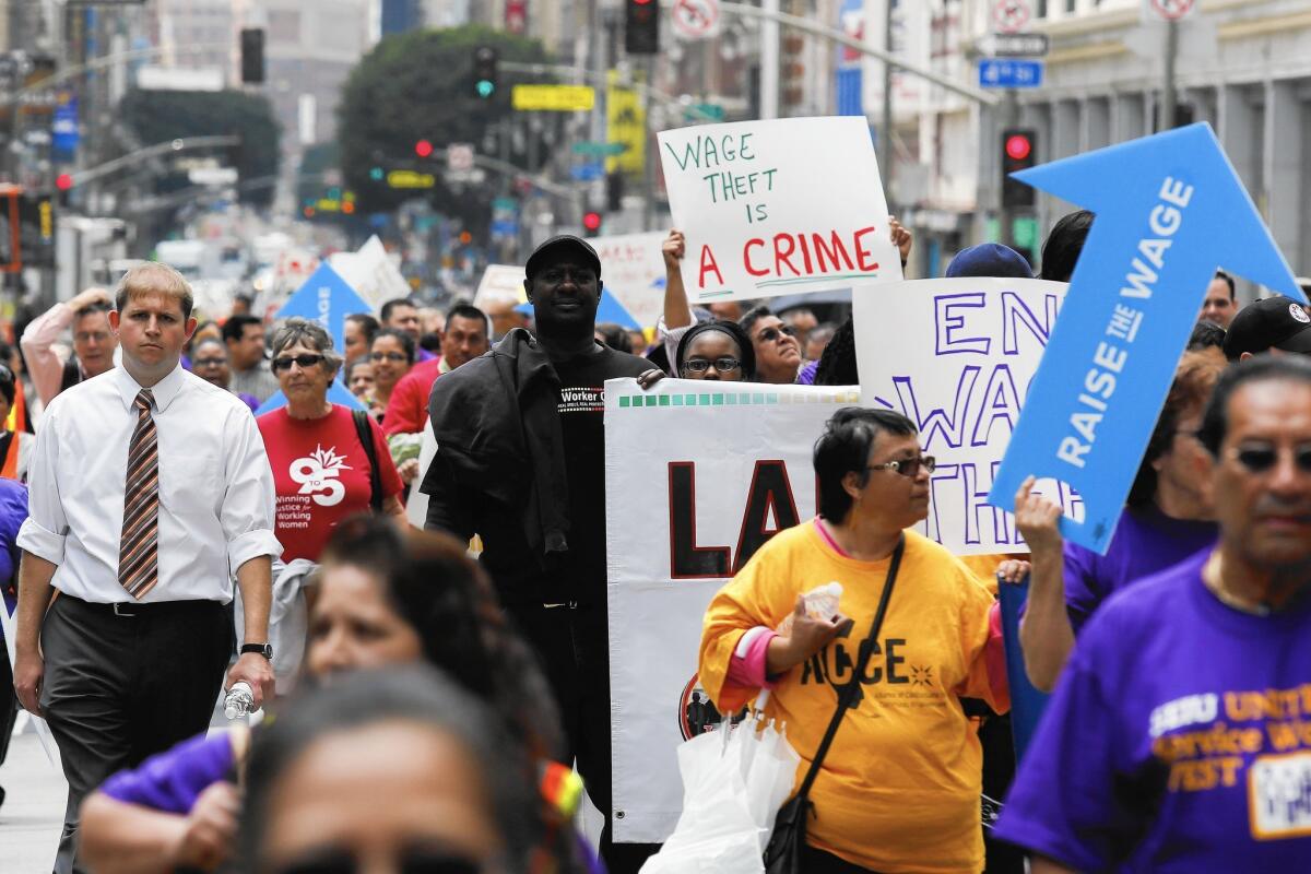 Worker wages will get an additional boost from higher minimum wages taking effect in several cities and states. Above, demonstrators in L.A. in May push for a higher wage floor.