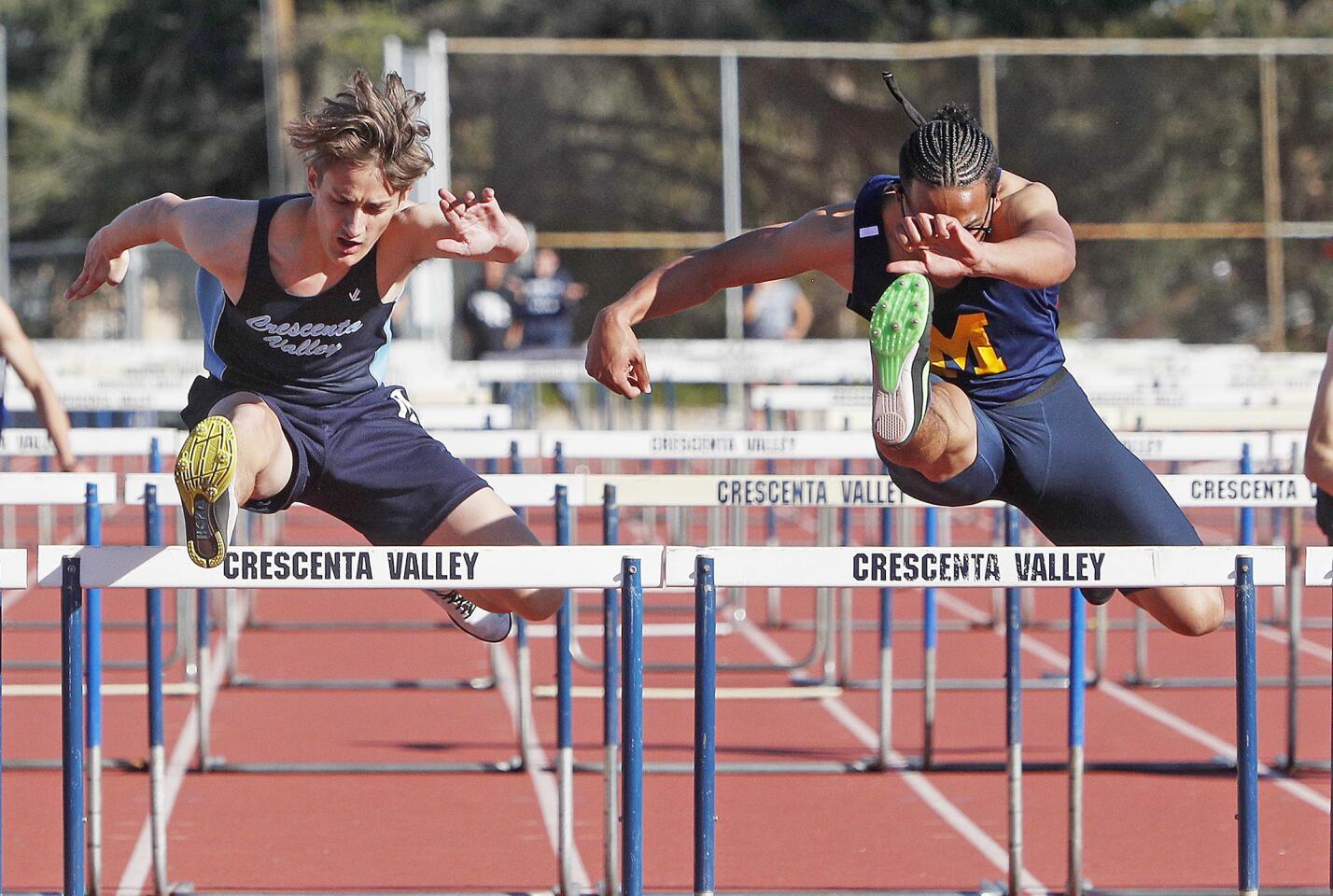 Crescenta Valley's Vince Lieberman is just ahead of Muir's Reggie Miles in the boys' 110 hurdles on the final hurdle in a Pacific League track meet at Crescenta Valley High School on Thursday, March 14, 2019. Lieberman beat Miles by 0.06 seconds. The meet featured schools from Crescenta Valley, Burbank, and Muir.