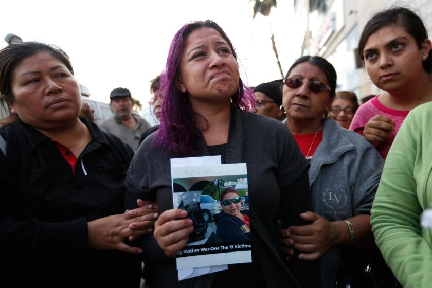 Jennifer Ruiz, 26, attends a vigil in Los Angeles for her mother, Rosa "Rosalba" Ruiz, who was one of 13 people killed in the tour bus crash in Desert Hot Springs.