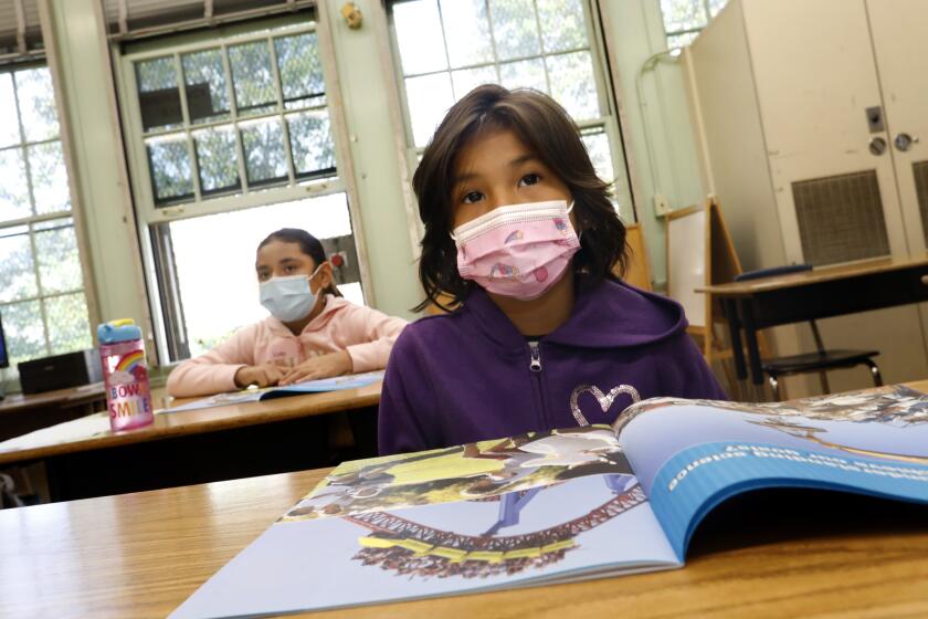 Students wearing masks listen to teacher Dorene Scala during third grade summer school at Hooper Avenue School in June, 2021