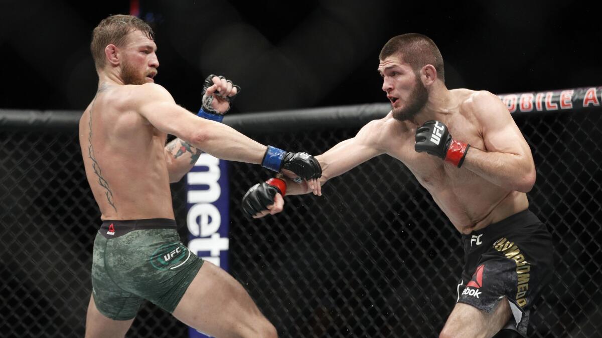 Conor McGregor, left, fights Khabib Nurmagomedov during a UFC 229.