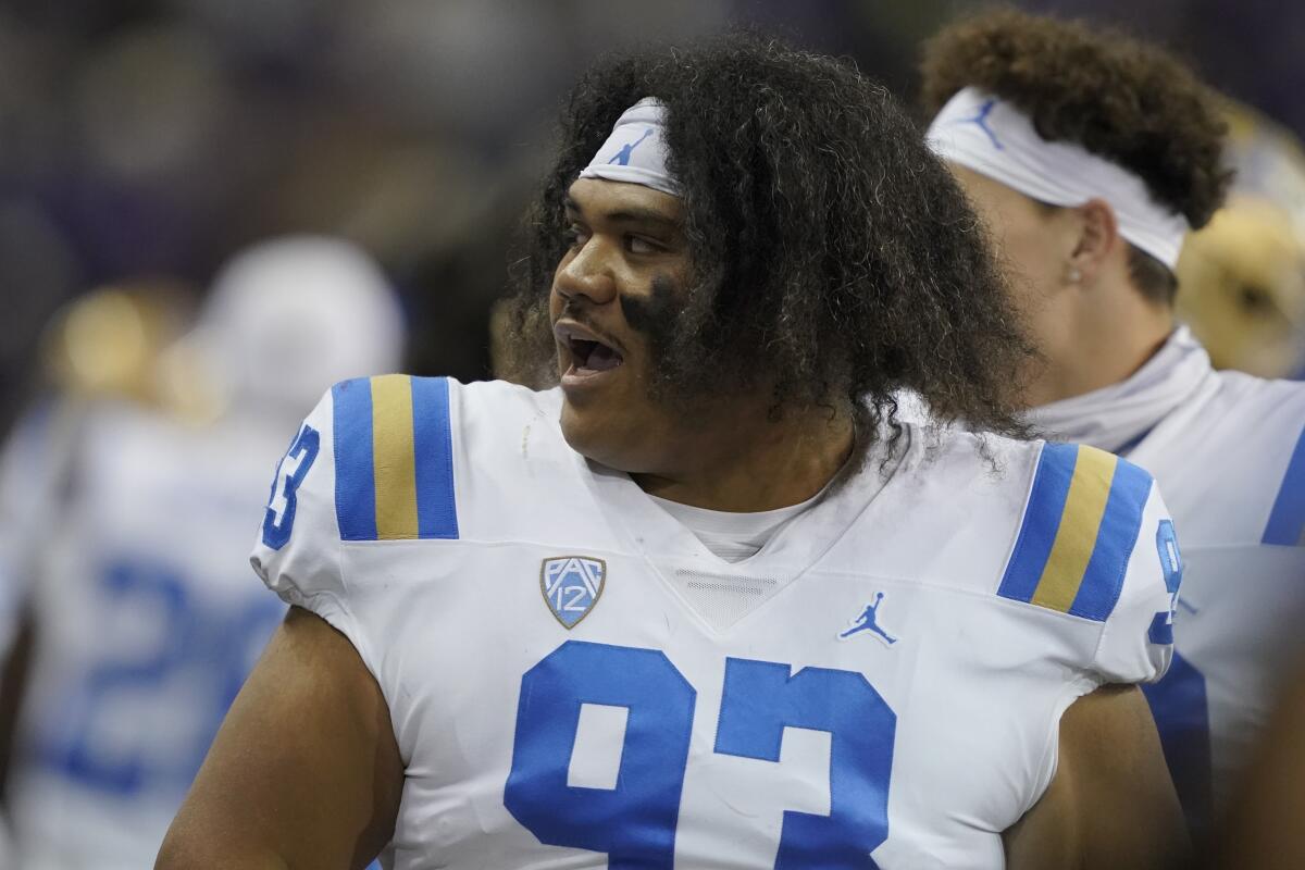 UCLA defensive lineman Jay Toia reacts on the bench after a game against Washington.