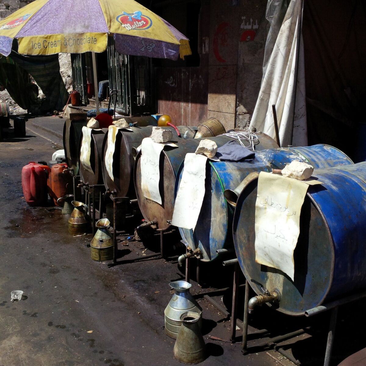 A makeshift gas station provides different varieties of fuel.