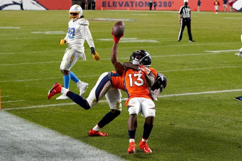 Denver Broncos wide receiver K.J. Hamler (13) celebrates his game-tying touchdown against the Los Angeles Chargers during the second half of an NFL football game, Sunday, Nov. 1, 2020, in Denver. The Broncos won 31-30. (AP Photo/David Zalubowski)