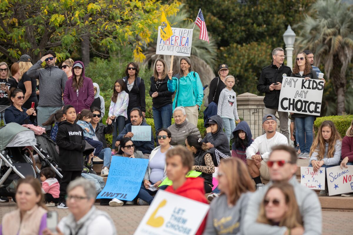 Teachers, parents and students stage a sit out to protest vaccine mandates in Balboa Park on Oct. 18.