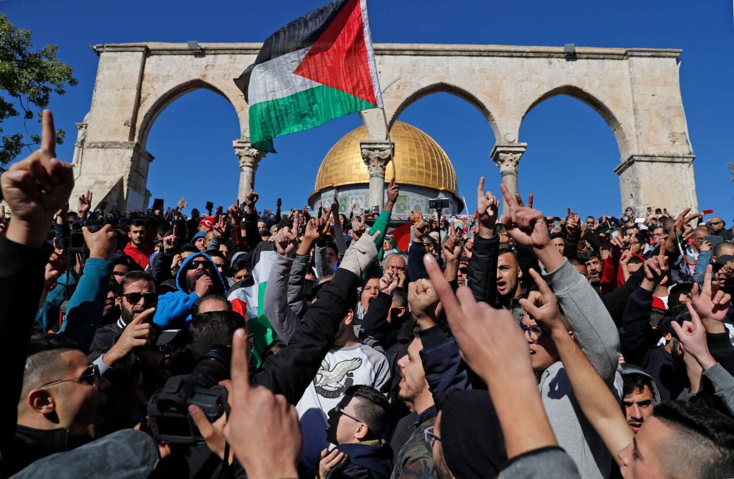 Palestinian Muslim worshipers shout slogans during Friday prayers in front of the Dome of the Rock mosque in Jerusalem's Old City. Israel deployed hundreds of additional police officers following Palestinian calls for protests after U.S. President Trump's recognition of Jerusalem as Israel's capital.