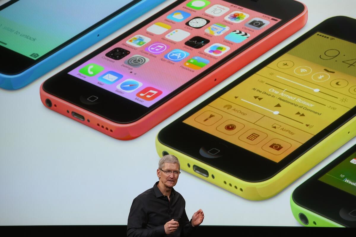 Apple chief Tim Cook unveils the iPhone 5C during an event in 2013 in Cupertino, Calif.
